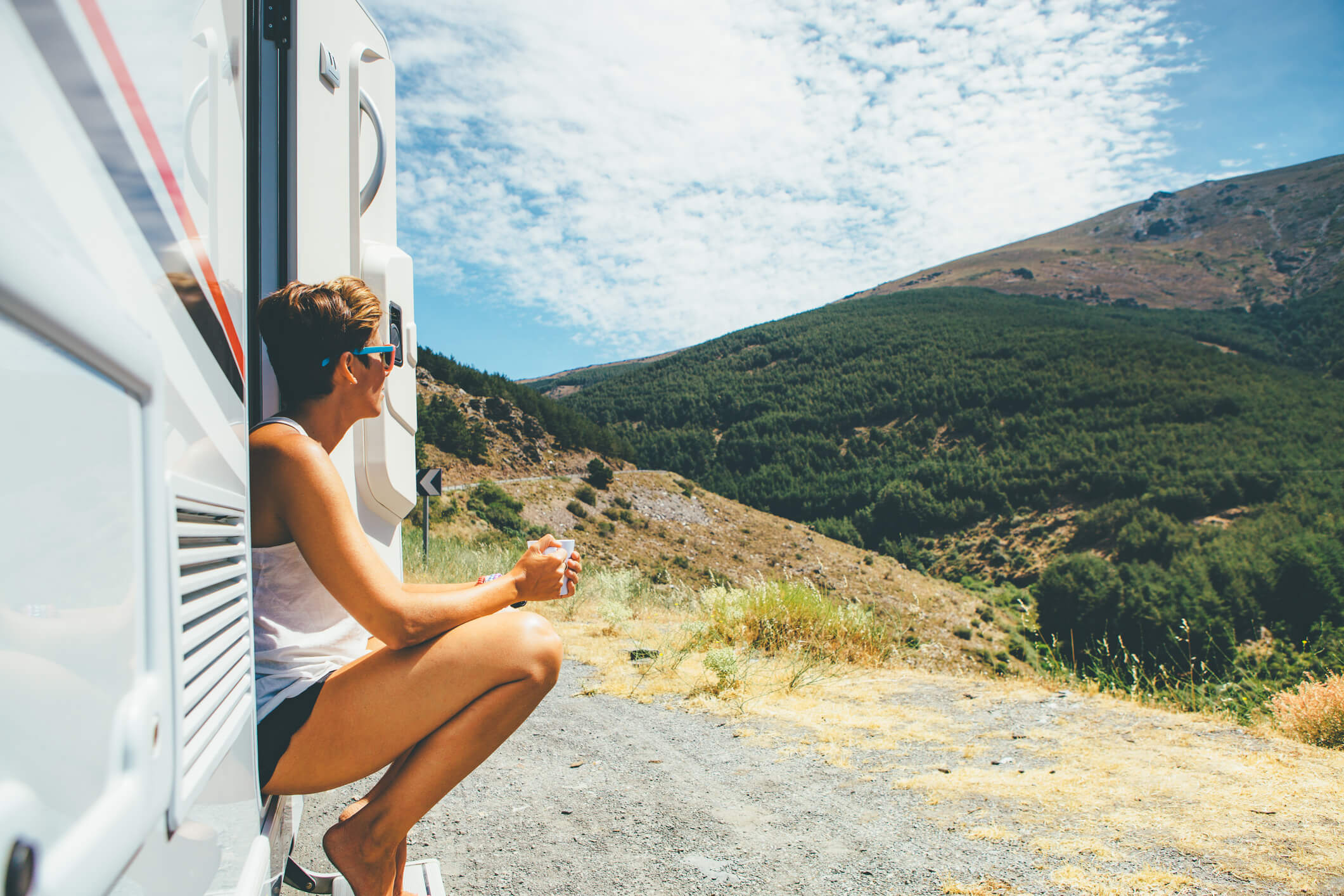 woman sitting in doorway of travel trailer